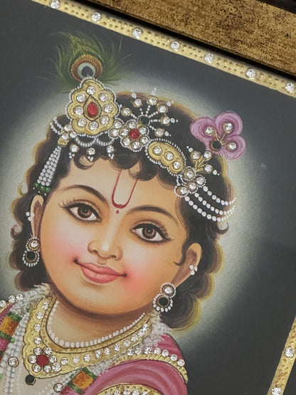 Close-up of Baby Krishna painting showing gold detailing and handpainted finish