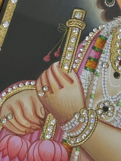Close-up of Baby Krishna painting showing gold detailing and handpainted finish