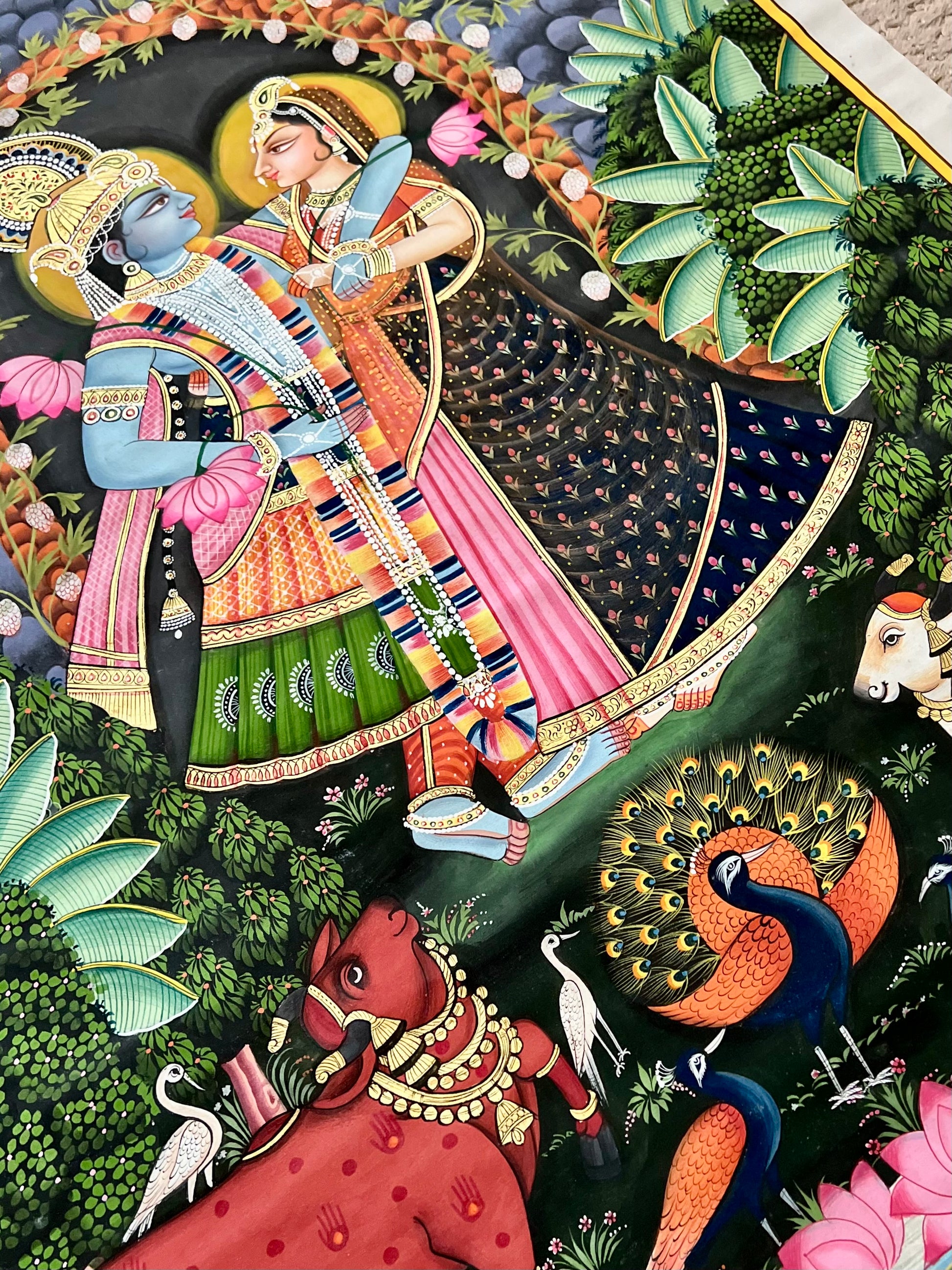 Close-up of Radha-Krishna Pichwai artwork showing gold leaf detailing and fine handpainting