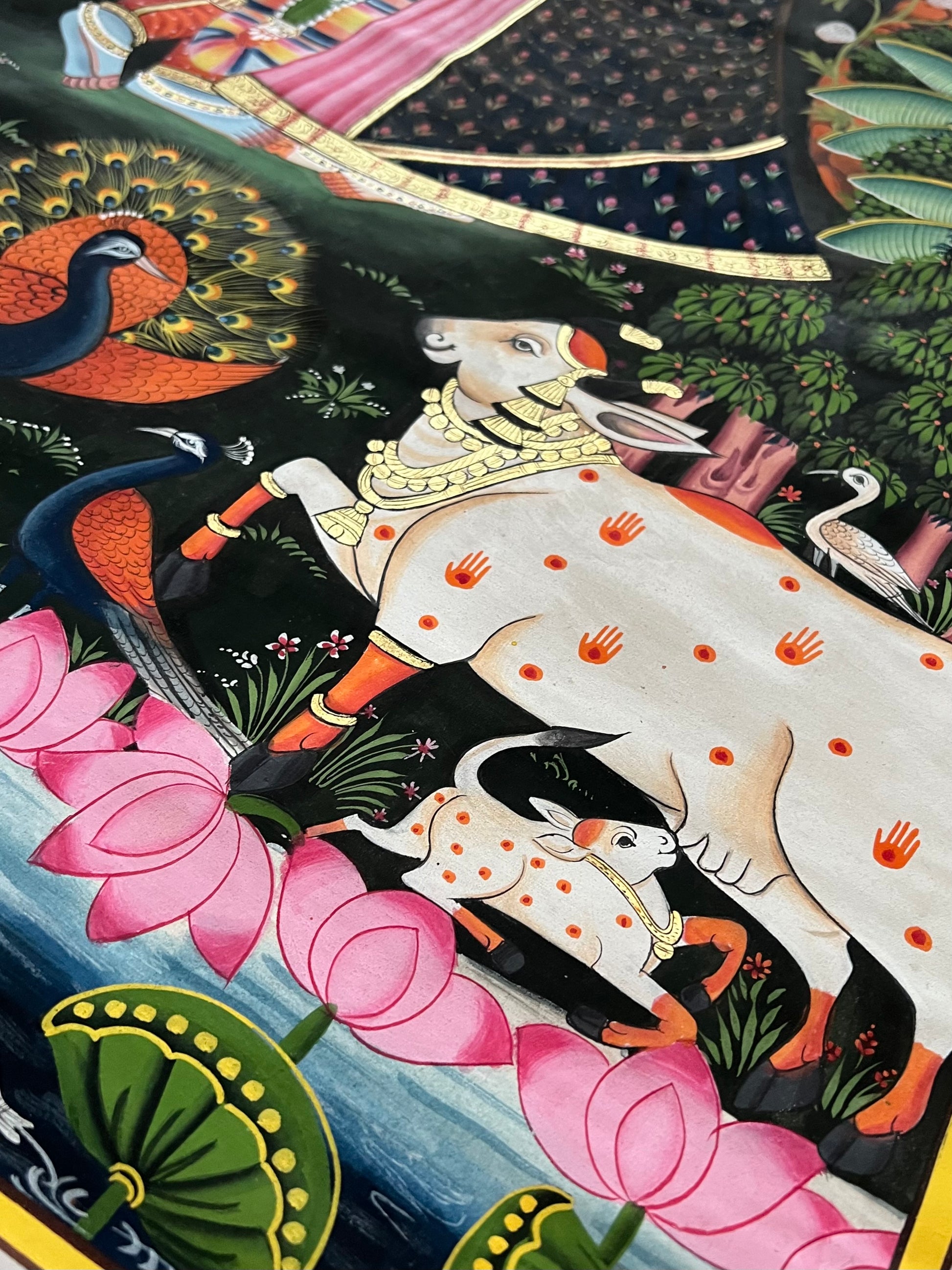Close-up of Radha-Krishna Pichwai artwork showing gold leaf detailing and fine handpainting