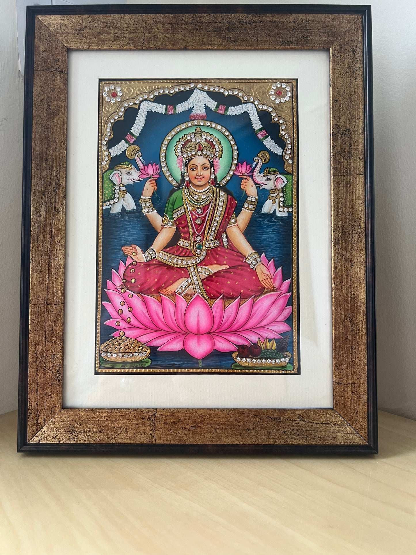 Close-up of Maa Lakshmi painting showing gold foil detailing and intricate handpainted finish