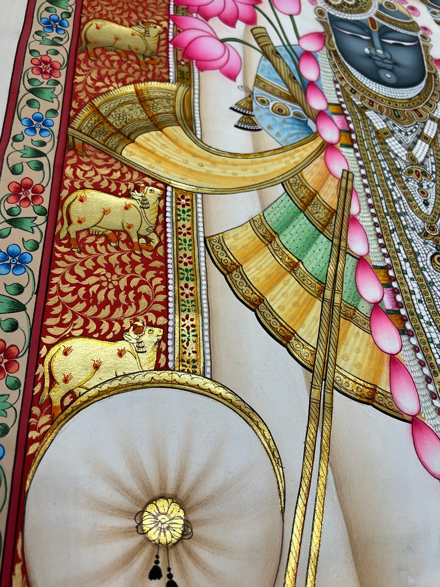 Close-up of Shreenathji Pichwai artwork showing gold leaf detailing and intricate brushwork