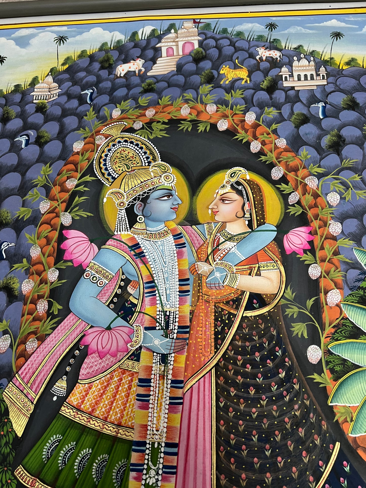 Close-up of Radha-Krishna Pichwai artwork showing gold leaf detailing and fine handpainting