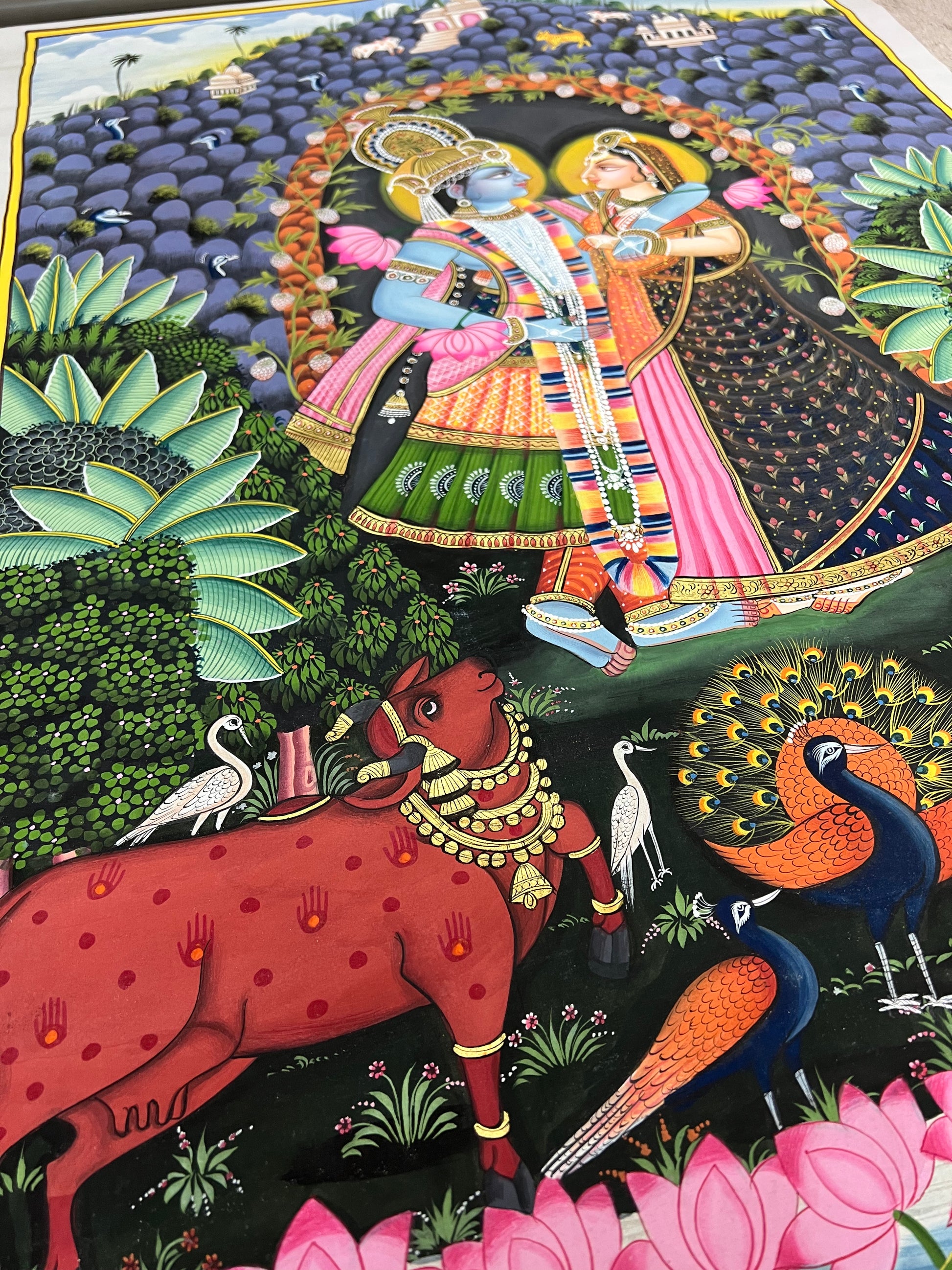 Close-up of Radha-Krishna Pichwai artwork showing gold leaf detailing and fine handpainting