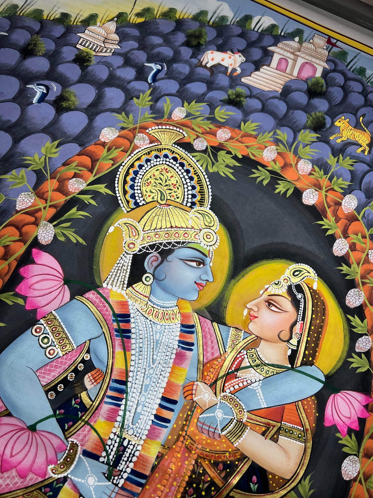 Close-up of Radha-Krishna Pichwai artwork showing gold leaf detailing and fine handpainting