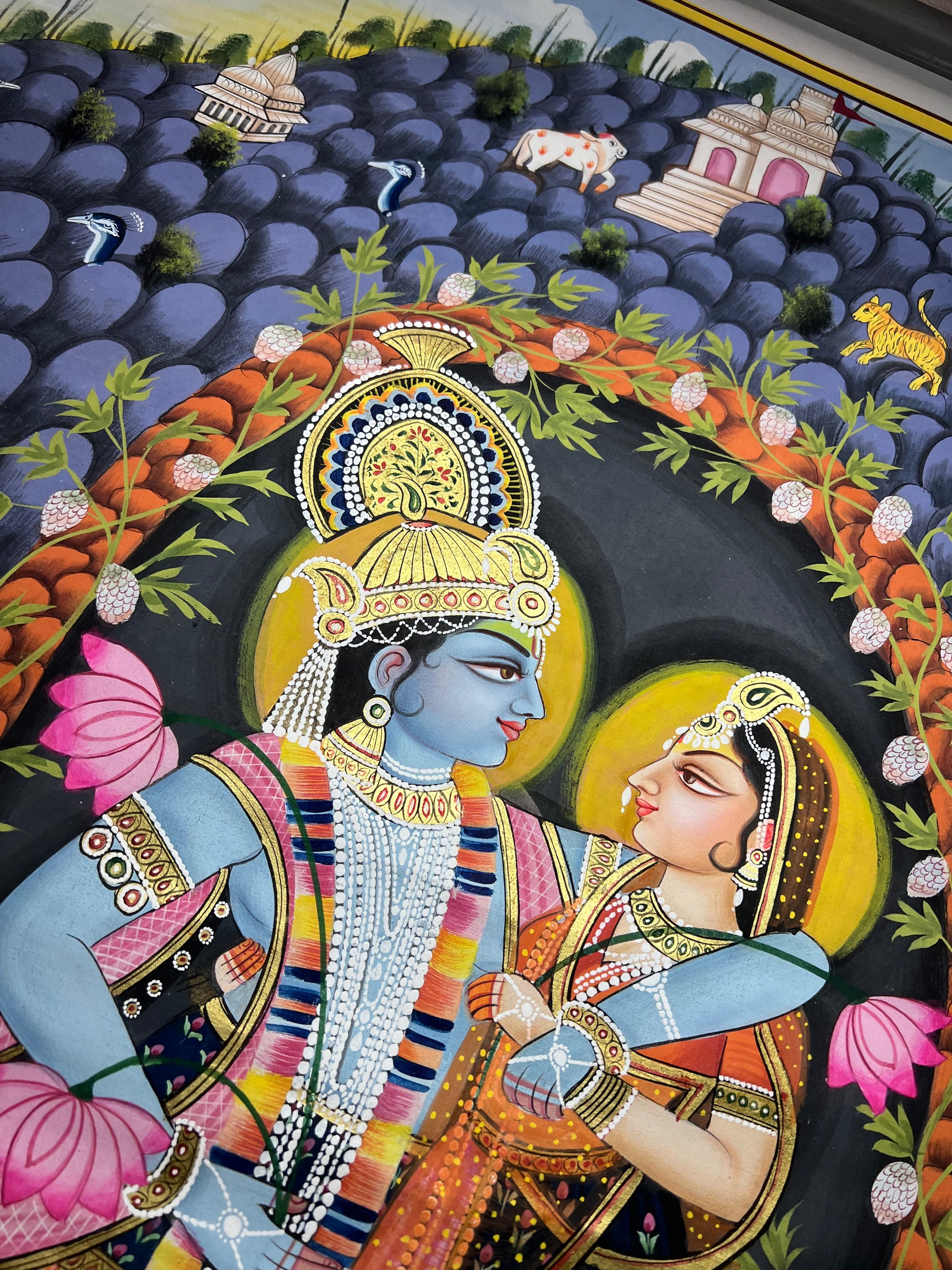 Close-up of Radha-Krishna Pichwai artwork showing gold leaf detailing and fine handpainting