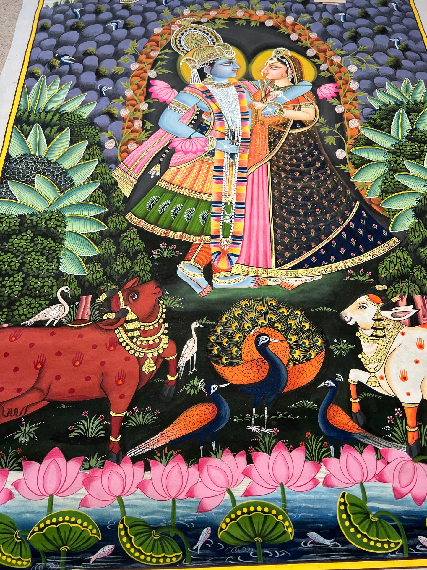 Close-up of Radha-Krishna Pichwai artwork showing gold leaf detailing and fine handpainting