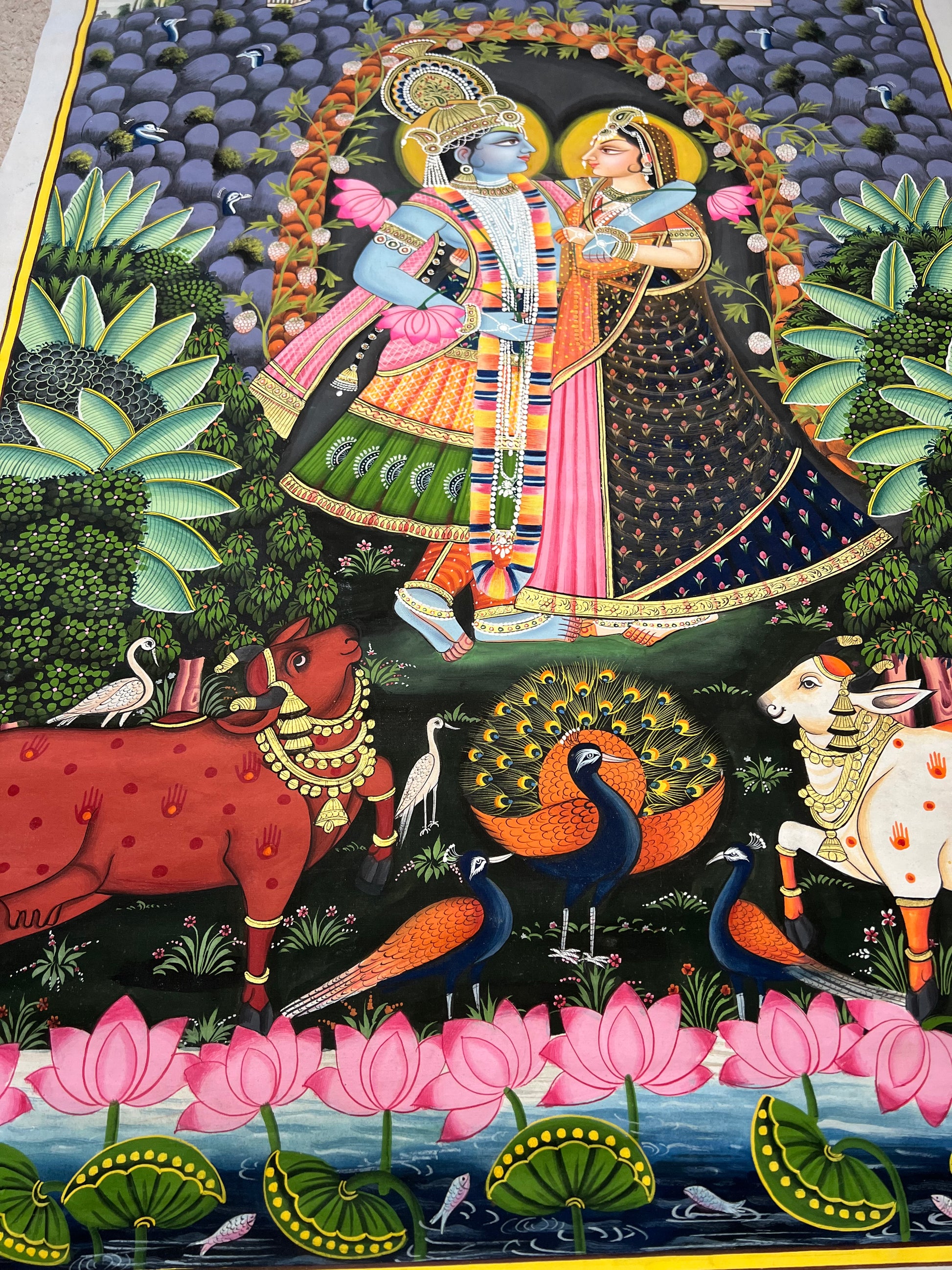 Close-up of Radha-Krishna Pichwai artwork showing gold leaf detailing and fine handpainting