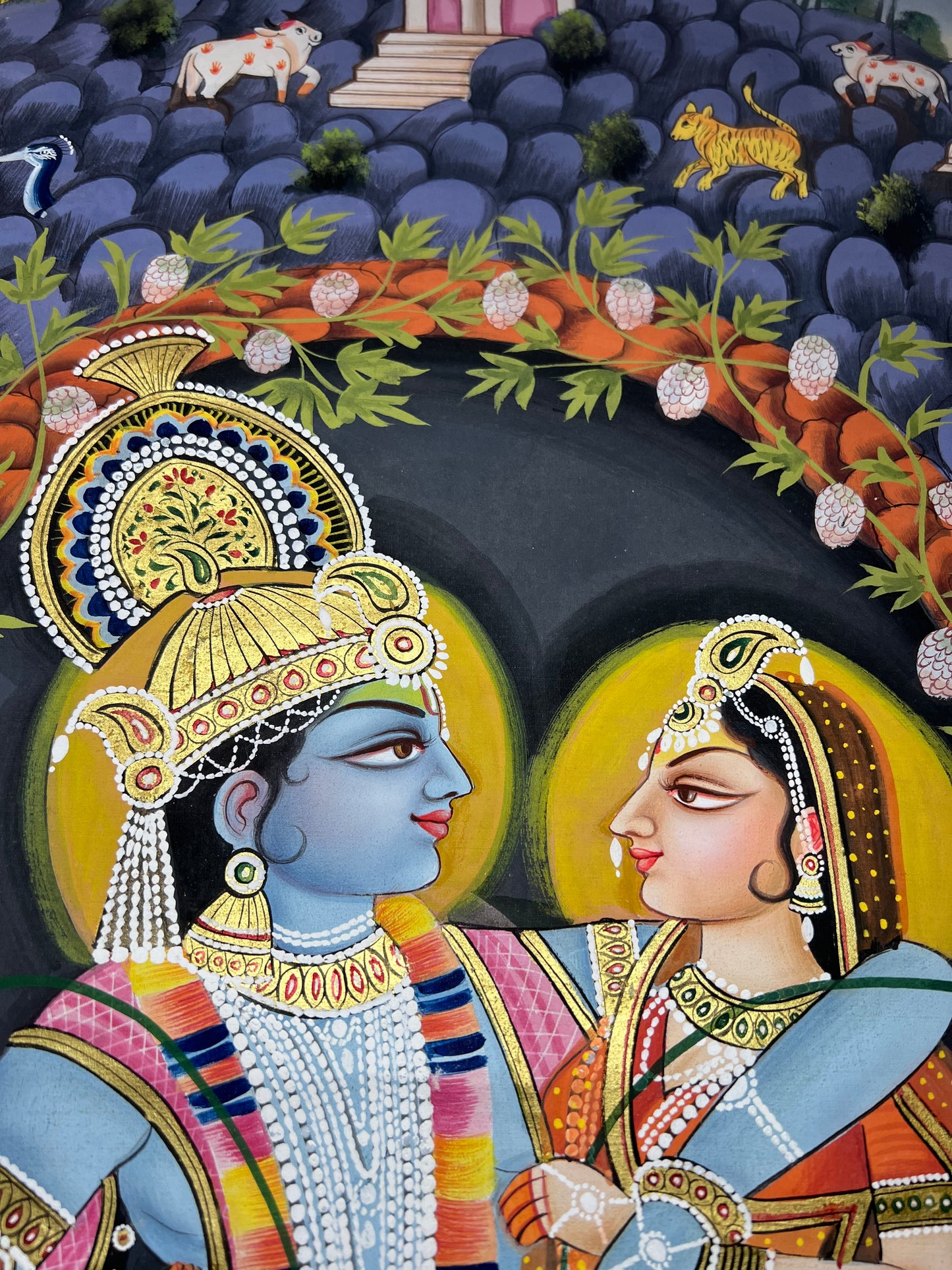 Close-up of Radha-Krishna Pichwai artwork showing gold leaf detailing and fine handpainting