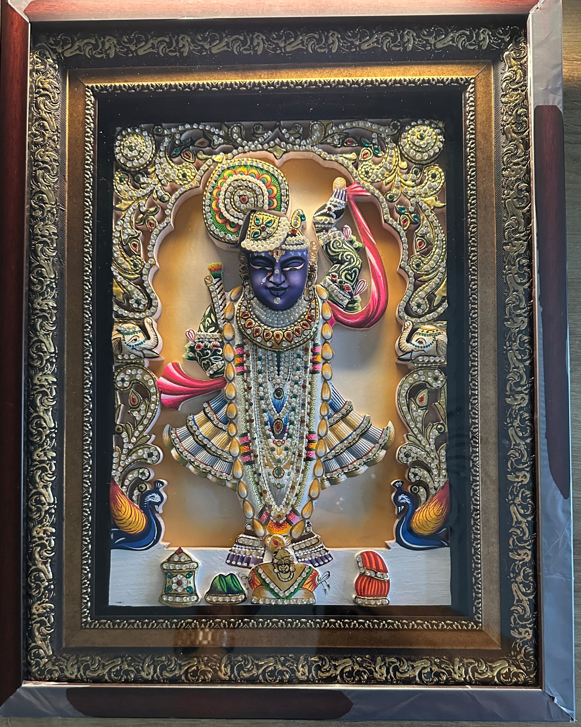Close-up of Shreenathji 3D artwork showing gold leaf detailing and Swarovski crystal embellishments