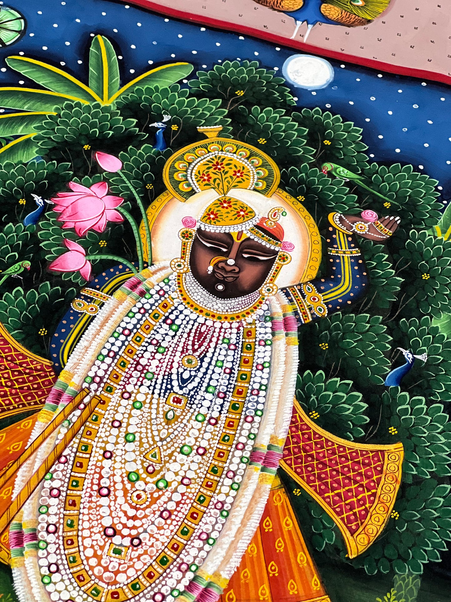 Close-up of handpainted Pichwai artwork showing intricate brushwork and traditional detailing