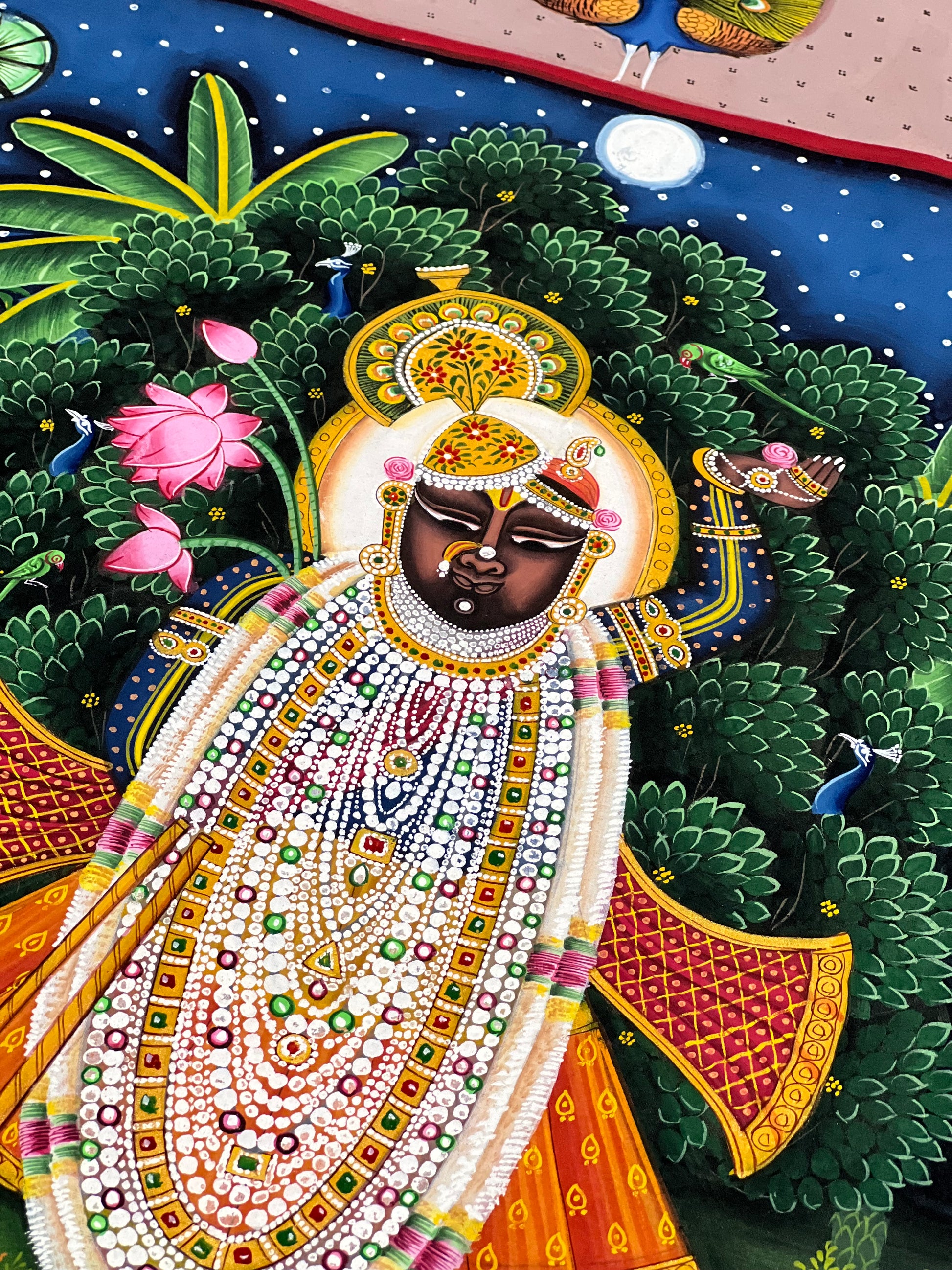 Close-up of handpainted Pichwai artwork showing intricate brushwork and traditional detailing