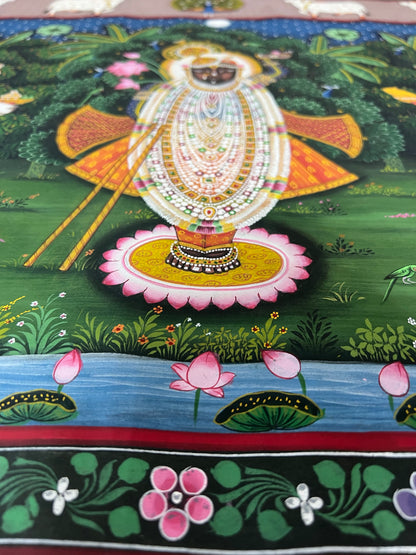 Close-up of handpainted Pichwai artwork showing intricate brushwork and traditional detailing