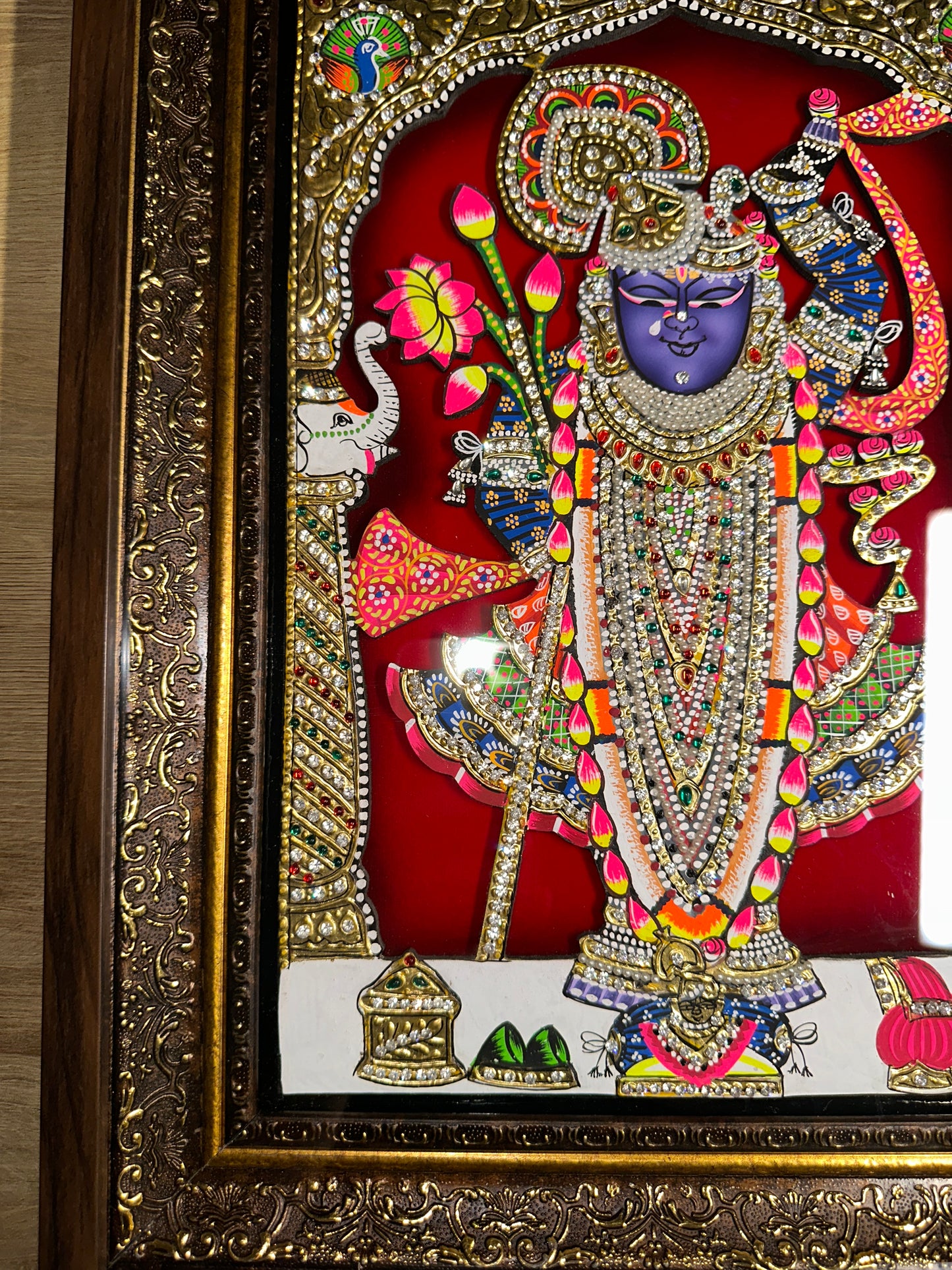 Close-up of Shreenathji artwork showing 24kt gold leaf detailing